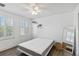 A bedroom with plantation shutters, hardwood floors and neutral paint at 530 Harriswood Ct, Davenport, FL 33837