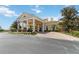 Elegant clubhouse entrance featuring stately columns and a well-manicured landscape at 530 Harriswood Ct, Davenport, FL 33837