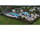 Community pool area with sun loungers, umbrellas, splash pad, and well-maintained landscaping at 530 Harriswood Ct, Davenport, FL 33837