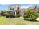 Beautiful two-story home with stone accents, manicured lawn, and lush landscaping for enhanced curb appeal at 530 Harriswood Ct, Davenport, FL 33837