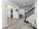 Inviting living space with wood-look tile flooring, archways, and staircase leading to the upper level at 530 Harriswood Ct, Davenport, FL 33837