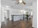 The second story of the home has hardwood floors, black metal railing and doorways to other rooms at 530 Harriswood Ct, Davenport, FL 33837