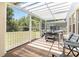 Enclosed patio with an outdoor dining area and a hot tub to relax in at 530 Harriswood Ct, Davenport, FL 33837