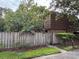 Charming townhome featuring a beautiful wooded exterior behind a fence and lush landscaping at 5302 Bamboo Ct # 447, Orlando, FL 32811