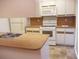Kitchen features white cabinets and appliances at 5327 Bamboo Ct # 426, Orlando, FL 32811
