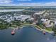 Beautiful aerial view of a lakeside community with waterfront buildings, walking paths, and docks under a blue sky at 5350 Penway Dr, Orlando, FL 32814