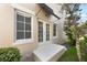 A view of the backyard, accessible through glass double doors and a small cement porch at 5350 Penway Dr, Orlando, FL 32814