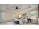 Main bedroom featuring a ceiling fan, two large windows, and a tray ceiling that adds architectural detail at 5350 Penway Dr, Orlando, FL 32814