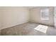 This bedroom features neutral walls and carpet and a window with natural light at 5350 Penway Dr, Orlando, FL 32814