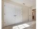 A large double-door closet with neutral walls provides ample storage space at 5350 Penway Dr, Orlando, FL 32814