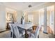 Well-lit dining room featuring decorative columns, neutral tones, and a modern table set for six at 5350 Penway Dr, Orlando, FL 32814