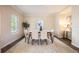 Well-lit dining room with a large window, modern table set for six, and decor that gives a touch of style and elegance at 5350 Penway Dr, Orlando, FL 32814