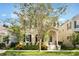 Charming two-story home with neutral-colored siding, complemented by a beautifully landscaped front yard and mature tree at 5350 Penway Dr, Orlando, FL 32814