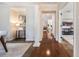 A spacious hallway featuring hardwood floors, decorative pillars, and neutral paint that creates an inviting and open transition at 5350 Penway Dr, Orlando, FL 32814