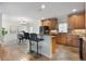 Open kitchen with breakfast bar, wooden cabinets, tile floors, and easy access to the dining area at 5350 Penway Dr, Orlando, FL 32814