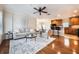 Bright living room featuring a comfortable sofa, stylish chairs, and an open layout into the kitchen with modern appliances at 5350 Penway Dr, Orlando, FL 32814
