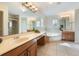 Spacious main bathroom with double vanity, soaking tub, tiled shower, and tile flooring at 5350 Penway Dr, Orlando, FL 32814