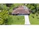 An aerial view showcases the well-maintained home with a driveway and lush green landscaping at 543 Silver Crse, Ocala, FL 34472