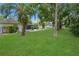 A sprawling green lawn compliments the covered patio and mature landscaping in the backyard at 543 Silver Crse, Ocala, FL 34472