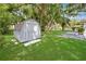 Backyard featuring a storage shed, a patio, a lush lawn and perimeter trees at 543 Silver Crse, Ocala, FL 34472