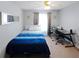This bedroom features neutral walls and carpet, a ceiling fan, and a work space at 543 Silver Crse, Ocala, FL 34472