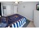 This bedroom features neutral walls, carpet, and a nautical themed comforter set at 543 Silver Crse, Ocala, FL 34472