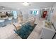 Open-concept dining room with modern glass table and a view of the breakfast bar and living spaces at 543 Silver Crse, Ocala, FL 34472