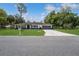 Charming single-story home featuring a well-manicured lawn and a long driveway leading to a two-car garage at 543 Silver Crse, Ocala, FL 34472