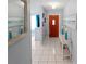 Bright hallway featuring tiled flooring and a view of the front entrance at 543 Silver Crse, Ocala, FL 34472
