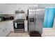 Kitchen area features stainless steel appliances and white cabinets at 543 Silver Crse, Ocala, FL 34472