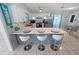 Kitchen with island seating, white cabinetry, and stainless steel appliances at 543 Silver Crse, Ocala, FL 34472