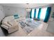 Well-lit living room showcasing white sectional sofa, glass coffee table, and beach-themed accents at 543 Silver Crse, Ocala, FL 34472
