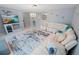 Stylish living room with a white sectional sofa, tile flooring, and beach decor at 543 Silver Crse, Ocala, FL 34472