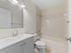 Bathroom featuring a shower and tub combo, a toilet, and a single sink vanity with large mirror at 6120 Peregrine Ave # A08-2, Orlando, FL 32819