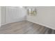 This bedroom offers neutral walls, modern gray flooring, a spacious closet, and sunlit window view at 6120 Peregrine Ave # A08-2, Orlando, FL 32819