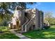 Exterior view of the condo showcasing the traditional architecture, stairs leading to the entrance, and green surroundings at 6120 Peregrine Ave # A08-2, Orlando, FL 32819