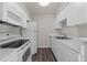 Bright kitchen featuring white appliances, modern counters, and ample storage at 6120 Peregrine Ave # A08-2, Orlando, FL 32819