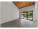 Bright living room with vaulted wood ceilings and sliding glass doors to the balcony at 6120 Peregrine Ave # A08-2, Orlando, FL 32819