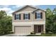 Charming two-story home featuring neutral siding, a two-car garage, and decorative shutters at 619 Wayland Dr, Haines City, FL 33844