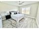 Bright bedroom featuring a ceiling fan, large window and wood-look vinyl flooring at 6449 Sw 180Th Cir, Dunnellon, FL 34432