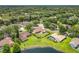 Aerial view of home with expansive backyard, lake view, and mature landscaping at 700 Wyckliffe Pl, Winter Springs, FL 32708