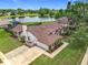 A beautiful aerial view of a single-Gathering home, a private lake, and a well-manicured landscape at 700 Wyckliffe Pl, Winter Springs, FL 32708