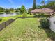 Expansive backyard features green space, a lake view, and partial fencing for privacy at 700 Wyckliffe Pl, Winter Springs, FL 32708