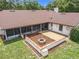 Aerial shot of backyard featuring a fire pit area, screened in lanai, and concrete patio at 700 Wyckliffe Pl, Winter Springs, FL 32708