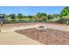 Backyard fire pit area with a wood retaining wall overlooking a picturesque pond and lush greenery at 700 Wyckliffe Pl, Winter Springs, FL 32708