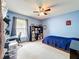Bedroom with blue walls, ceiling fan, and a desk at 700 Wyckliffe Pl, Winter Springs, FL 32708
