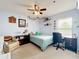 Cozy bedroom with blue walls, ceiling fan, comfortable furnishings, and a desk area for studying at 700 Wyckliffe Pl, Winter Springs, FL 32708