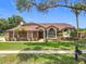 Charming single-story brick home with a well-kept lawn and mature trees at 700 Wyckliffe Pl, Winter Springs, FL 32708