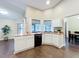 Bright kitchen featuring white cabinets, granite countertops, and stainless steel appliances at 700 Wyckliffe Pl, Winter Springs, FL 32708