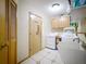 Functional laundry room with light wood cabinets, sink, washer, and dryer at 700 Wyckliffe Pl, Winter Springs, FL 32708